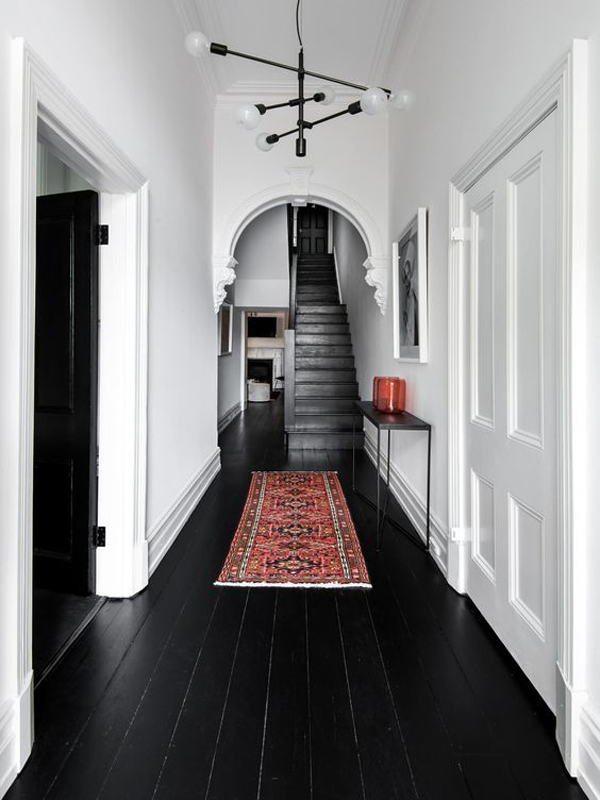 black-wood-hallway-floor-with-moroccan-rugs