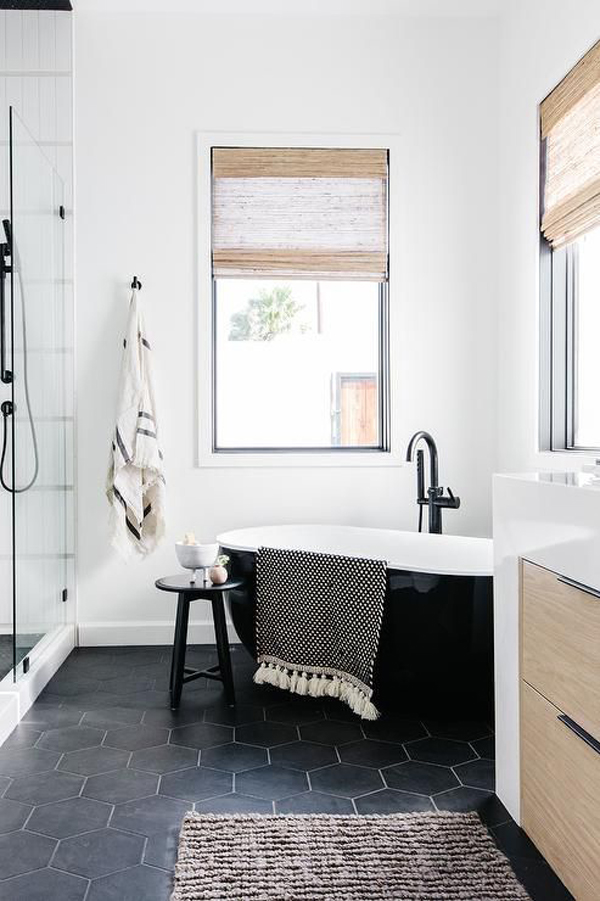 small-corner-bathtub-with-black-hexagon-floor-tiles