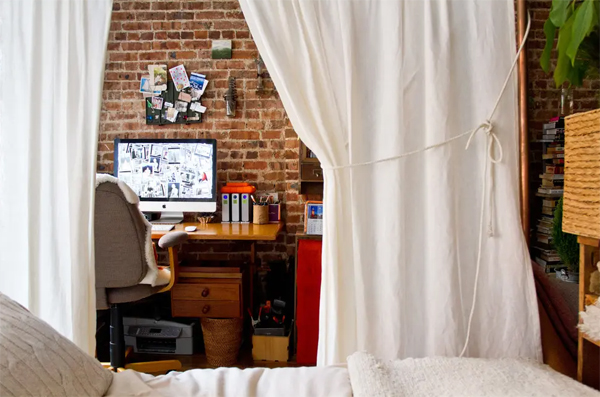 small-home-office-with-curtain-and-brick-exposed