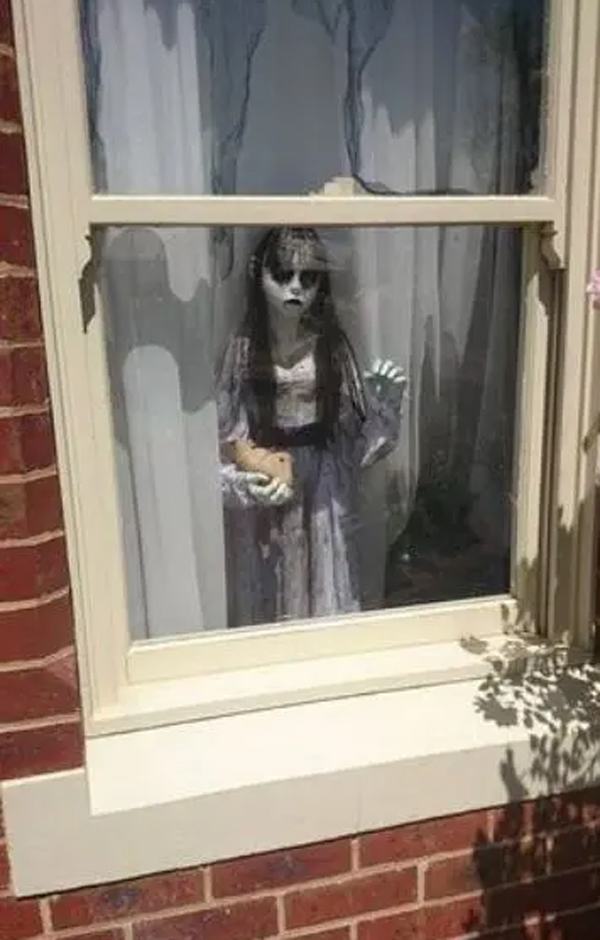 scary-girl-standing-window-decor