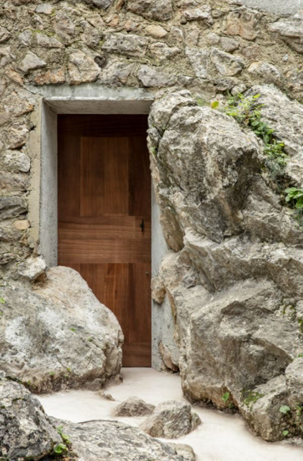 the-olive-front-door-with-rocks-wall