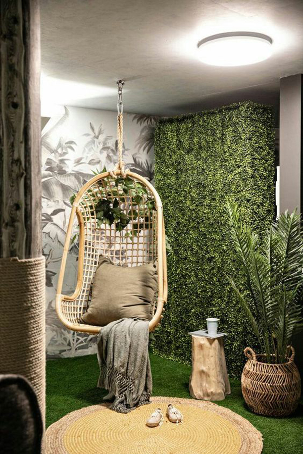 cozy-reading-nook-with-hang-rattan-chair-and-grass-wall