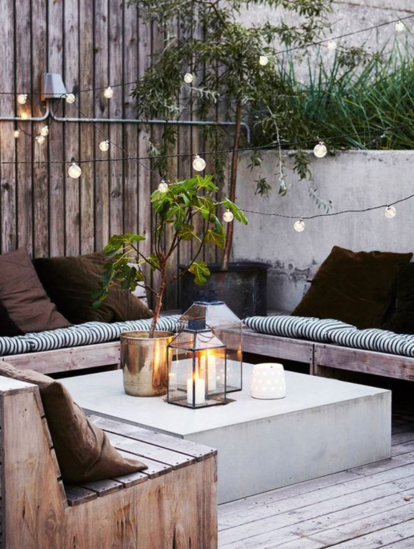 scandinavian-outdoor-patio-with-lantern-and-string-lights