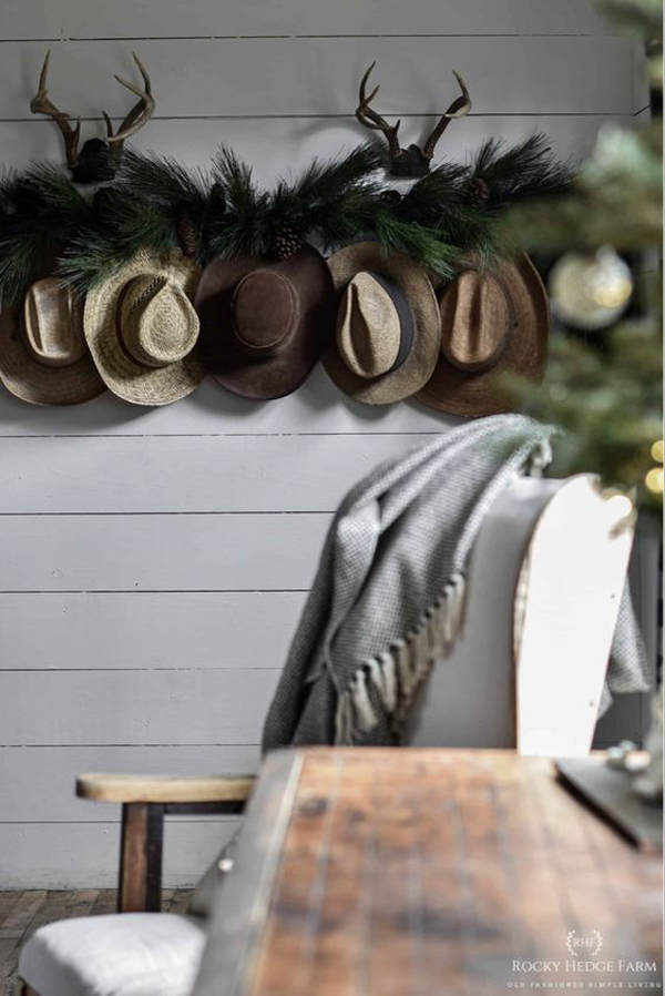 rustic-winter-entryway-with-lush-green-and-hat-decor