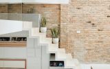 minimalist-glass-stair-railing-with-exposed-brick