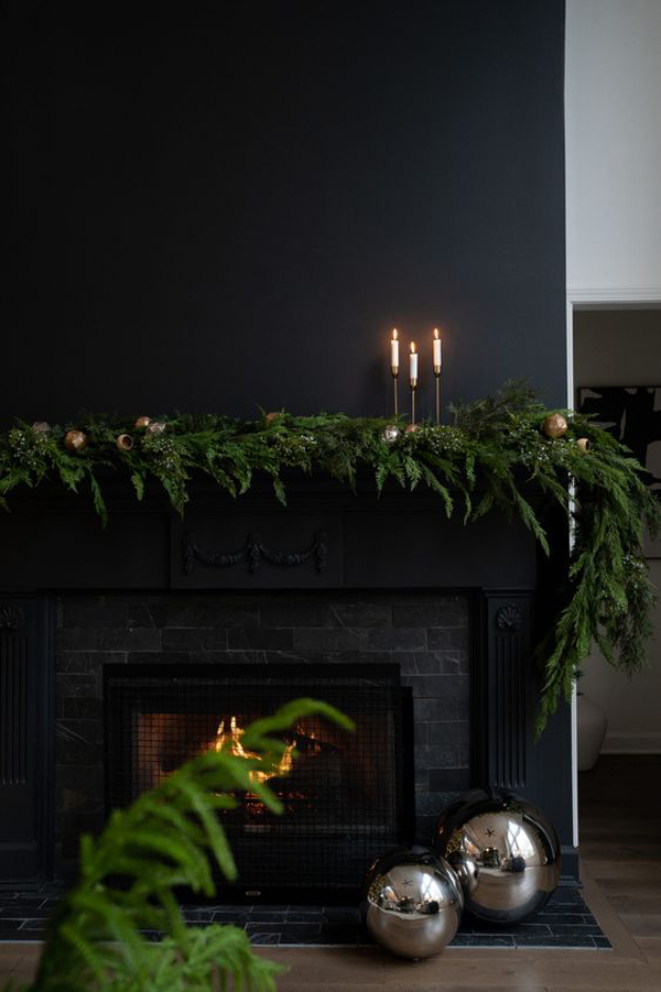 black-christmas-mantel-with-greenery