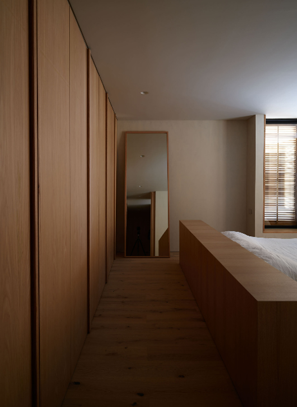 master-bedroom-with-large-wood-cabinet-and-standing-lamp