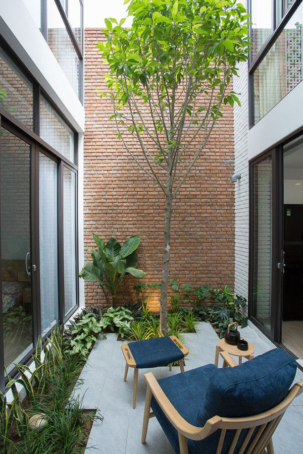 small-indoor-seating-garden-with-exposed-brick