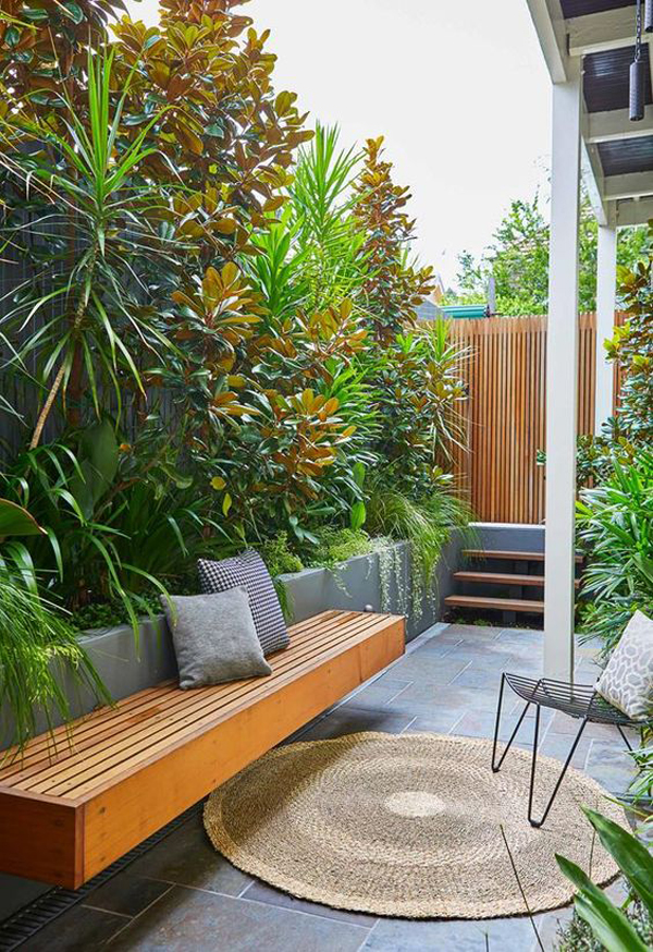 small-lush-backyard-garden-with-wooden-bench