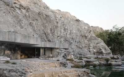 granite house with small river surroundings